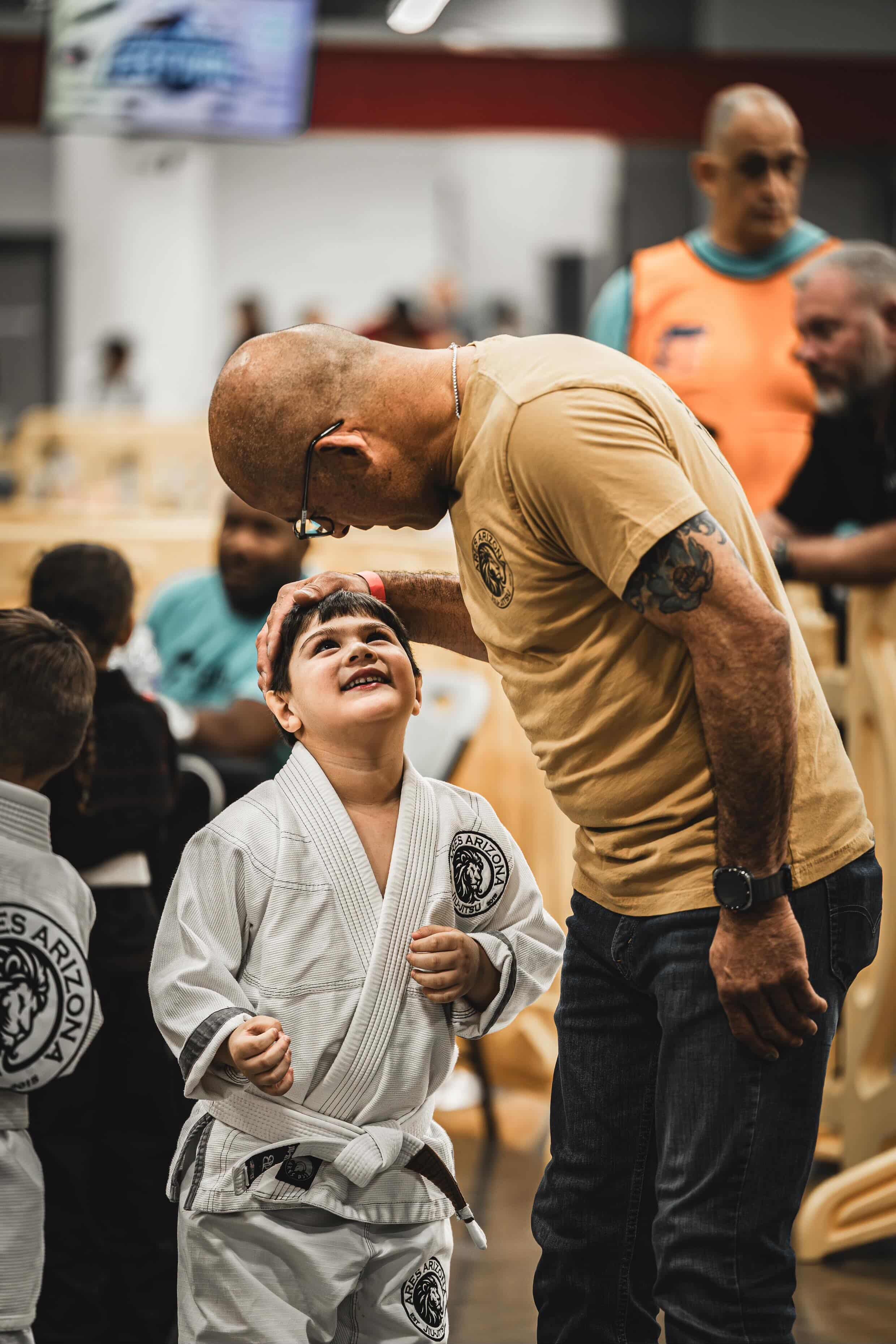 Coach hugging young medalist